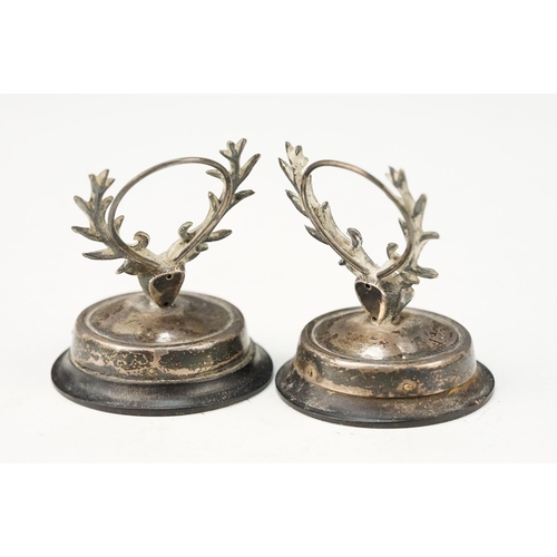 384 - Pair of early 20th Century Edwardian menu holders in the form of stags with red stone eyes, raised o... 