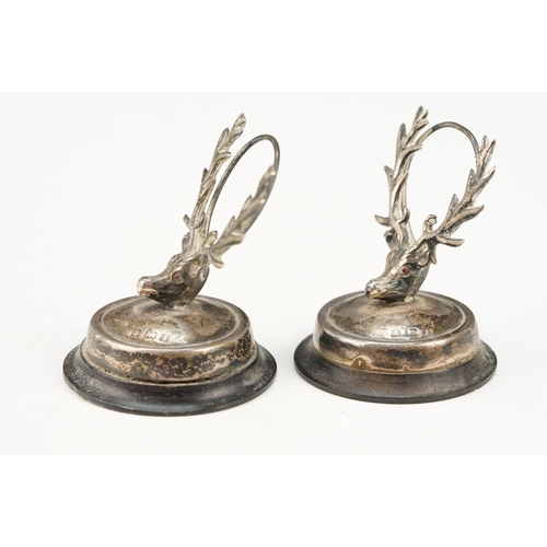 384 - Pair of early 20th Century Edwardian menu holders in the form of stags with red stone eyes, raised o... 