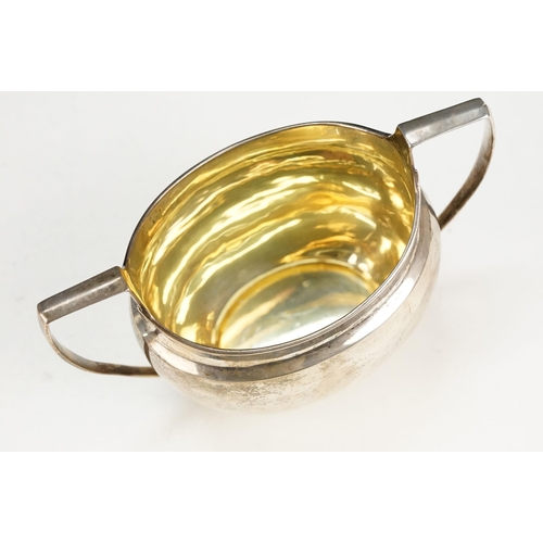 388 - 1920s silver hallmarked twin handled sugar bowl having a gilt interior with two stirrup handles. Hal... 