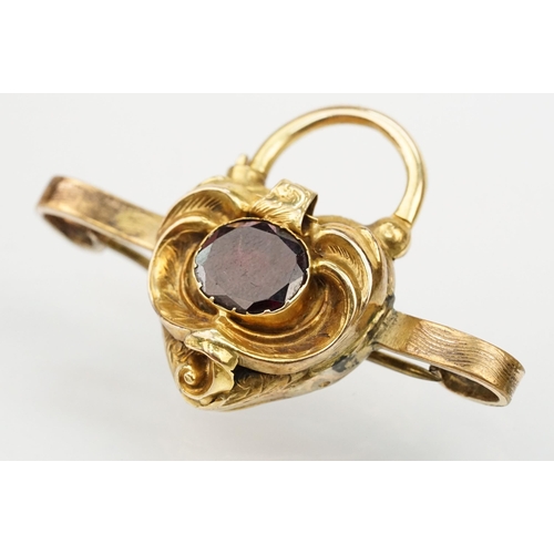 4 - 19th Century Victorian garnet bar brooch. The brooch having a padlock to centre set with an oval cut... 