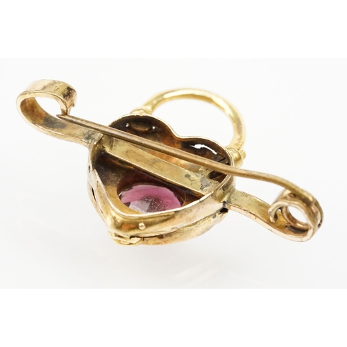 4 - 19th Century Victorian garnet bar brooch. The brooch having a padlock to centre set with an oval cut... 