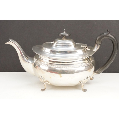 400 - Early 20th Century silver tea set comprising teapot, hot water pot and sugar bowl with ebonised wood... 