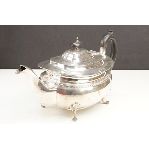 400 - Early 20th Century silver tea set comprising teapot, hot water pot and sugar bowl with ebonised wood... 