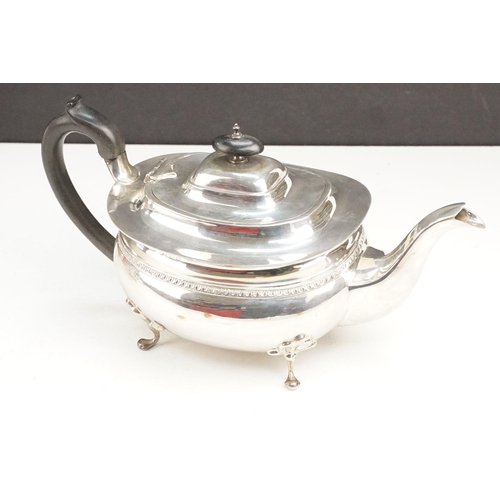 400 - Early 20th Century silver tea set comprising teapot, hot water pot and sugar bowl with ebonised wood... 