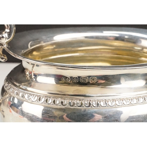 400 - Early 20th Century silver tea set comprising teapot, hot water pot and sugar bowl with ebonised wood... 