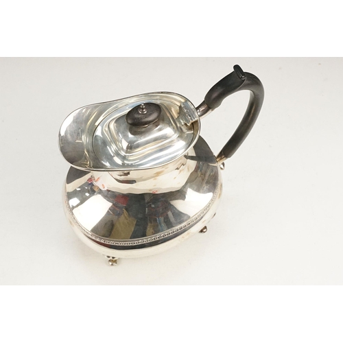 400 - Early 20th Century silver tea set comprising teapot, hot water pot and sugar bowl with ebonised wood... 