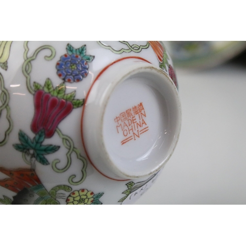 13 - Pair of Chinese famille rose shallow bowls and a matching tea bowl, each decorated with butterflies ... 