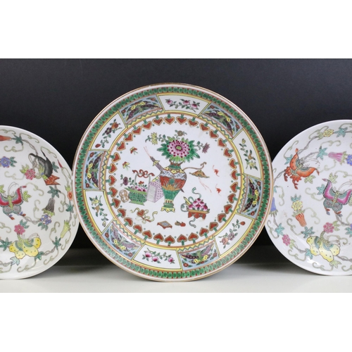 13 - Pair of Chinese famille rose shallow bowls and a matching tea bowl, each decorated with butterflies ... 