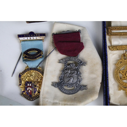 131 - A collection of masonic collectables to include jewels, sashes, books and associated regalia.