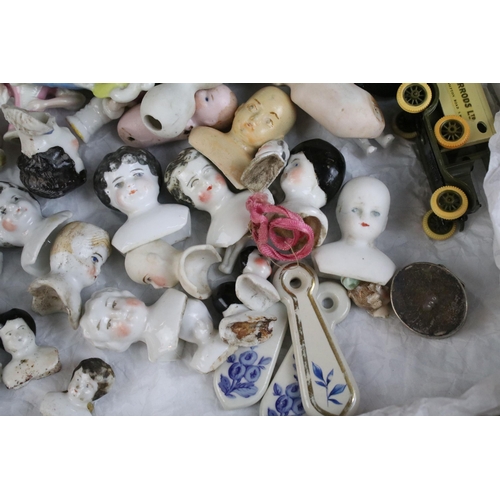 139 - A large collection of antique ceramic pin cushion dolls and doll heads of various sizes and styles.