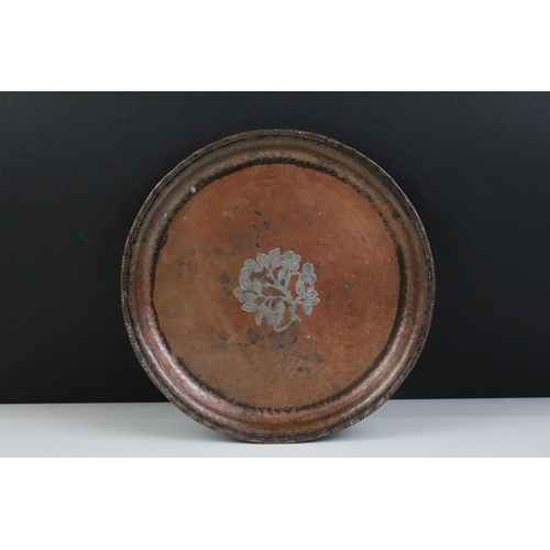 158 - Hugh Wallace copper tray plate with berry and foliage inlay and hammered edge, diameter 25cm