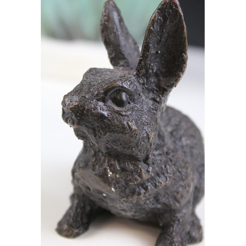 166 - Bronze figure of a rabbit, 10.5cm high, a bronzed star gazing stylised face mounted on marble base, ... 