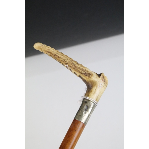 168 - Early 20th century riding crop with carved antler handle and silver plated mount and two Italian sho... 