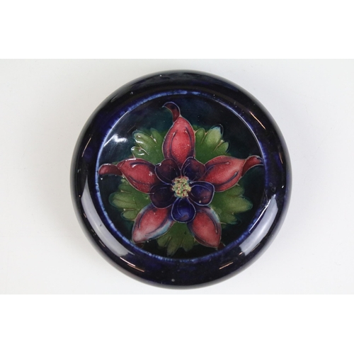 26 - Moorcroft inverted rim dish ashtray, diameter 11.5cm together with a pair of miniature porcelain dol... 