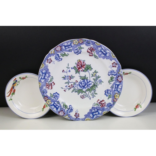 26 - Moorcroft inverted rim dish ashtray, diameter 11.5cm together with a pair of miniature porcelain dol... 