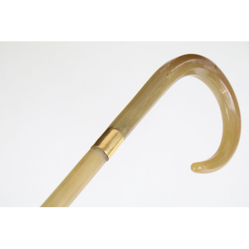 172A - An antique Rhino Horn walking stick with yellow metal band, approx 77cm in length, pre 1947 and Citi... 