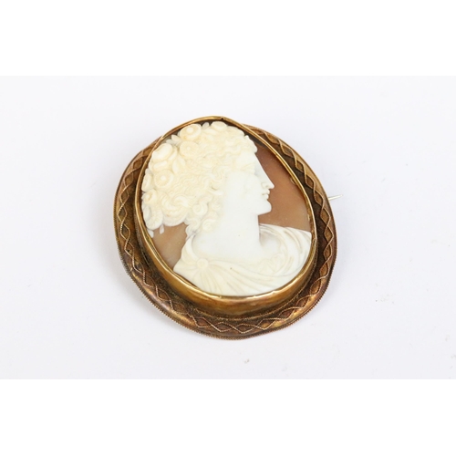 101A - A fully hallmarked 9ct gold mounted cameo brooch together with a second yellow metal mounted example... 