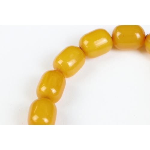 106A - An amber style beaded necklace with beads of cylindrical form.