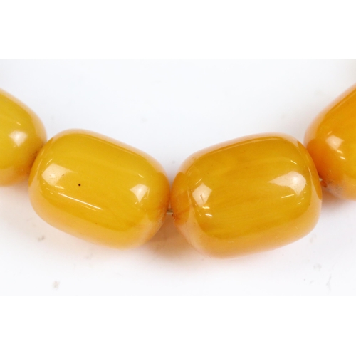 106A - An amber style beaded necklace with beads of cylindrical form.