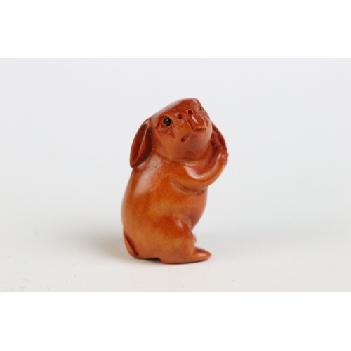 108 - Three miniature wood netsuke figures to include monkey, Chinese dragon and a signed rabbit