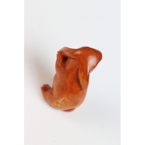 108 - Three miniature wood netsuke figures to include monkey, Chinese dragon and a signed rabbit