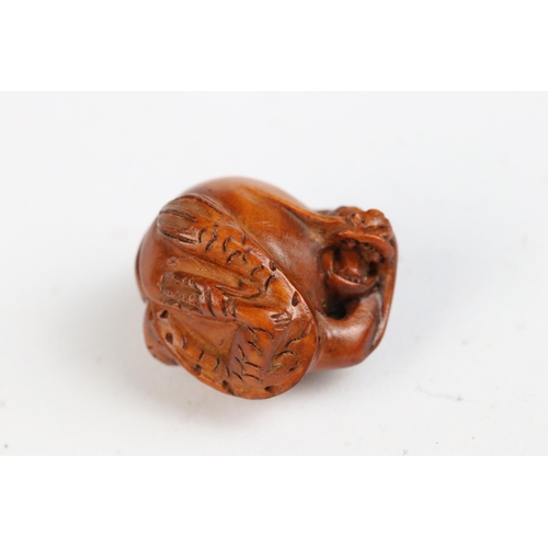 108 - Three miniature wood netsuke figures to include monkey, Chinese dragon and a signed rabbit