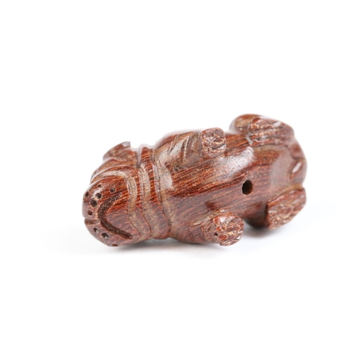 111 - Three miniature wood netsuke figures to include bulldog, money goat and face of a wise old man