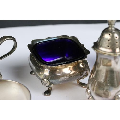 115 - A collection of hallmarked sterling silver to include cruet set, napkin rings and silver bangles.