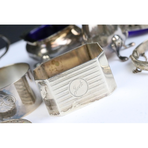 115 - A collection of hallmarked sterling silver to include cruet set, napkin rings and silver bangles.