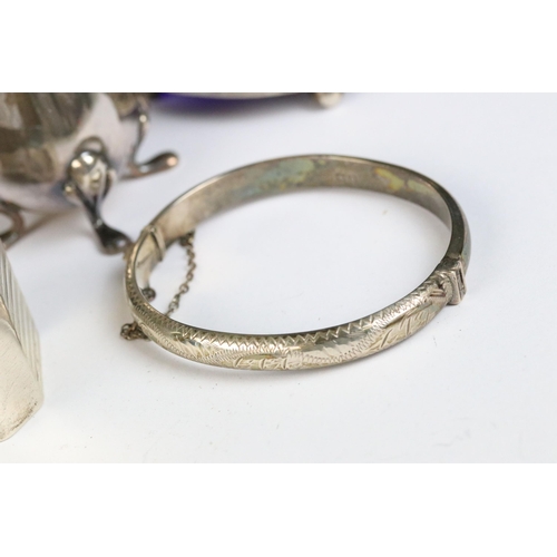 115 - A collection of hallmarked sterling silver to include cruet set, napkin rings and silver bangles.