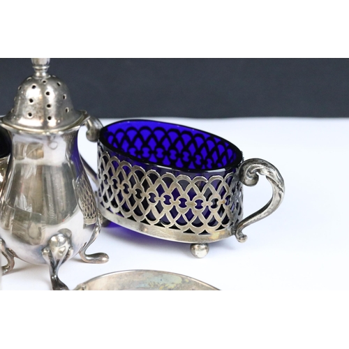 115 - A collection of hallmarked sterling silver to include cruet set, napkin rings and silver bangles.