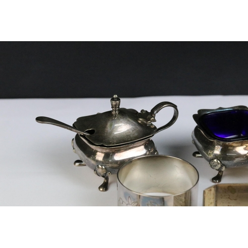 115 - A collection of hallmarked sterling silver to include cruet set, napkin rings and silver bangles.