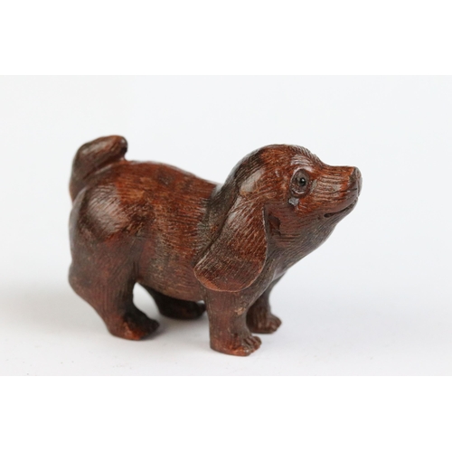 117 - Two carved wooden netsuke figures to include dog and a frog on stick