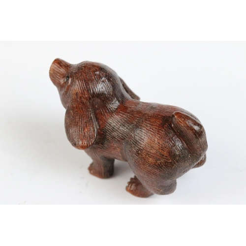 117 - Two carved wooden netsuke figures to include dog and a frog on stick