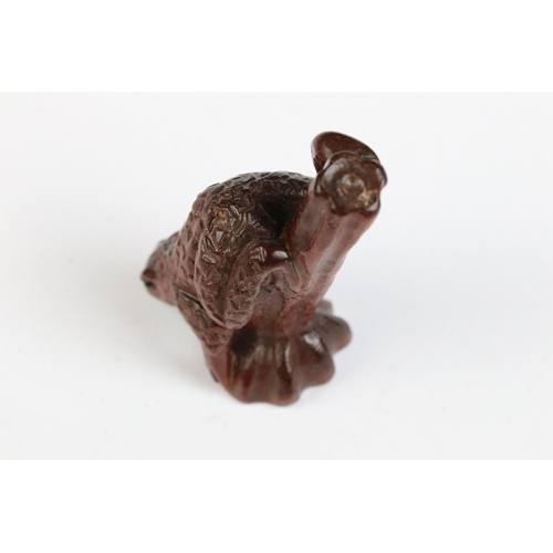 117 - Two carved wooden netsuke figures to include dog and a frog on stick