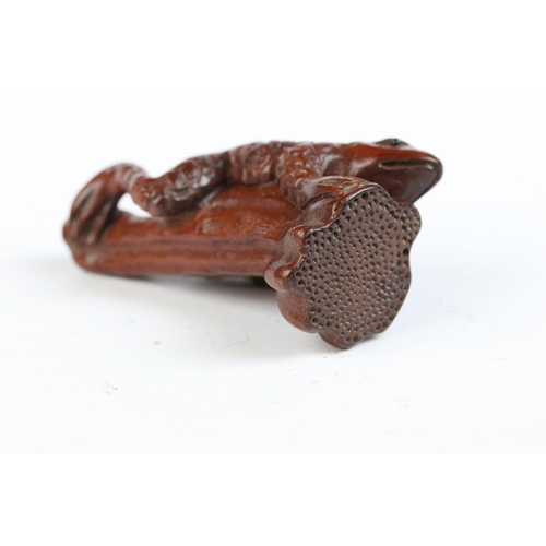 117 - Two carved wooden netsuke figures to include dog and a frog on stick