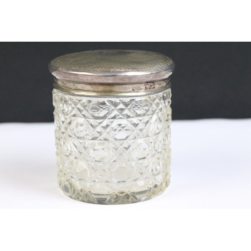 120 - A collection of three hallmarked silver topped cut glass vanity jars together with a collection of s... 