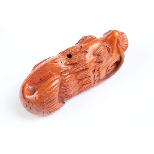 122 - Two carved wooden netsuke figures of Chinese dragons, one holding a large ball signed