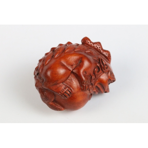 122 - Two carved wooden netsuke figures of Chinese dragons, one holding a large ball signed