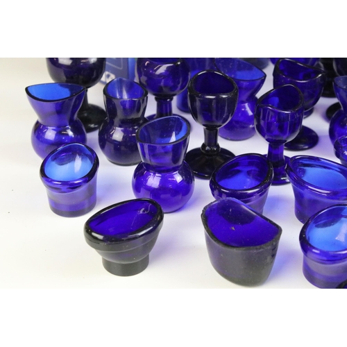 67 - Collection of 20th century Optrex blue glass eyebaths in various designs together with related acces... 