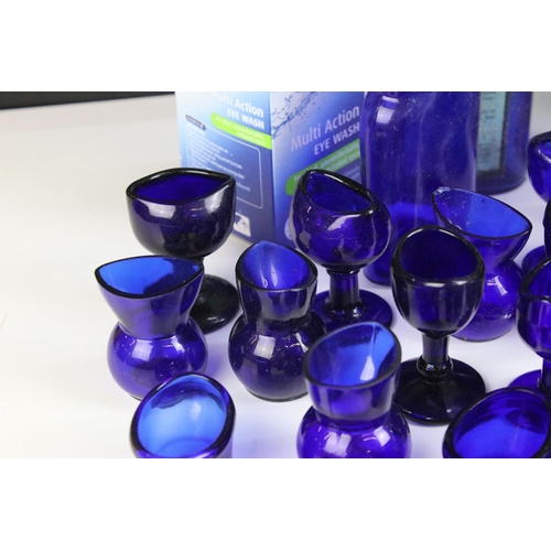 67 - Collection of 20th century Optrex blue glass eyebaths in various designs together with related acces... 