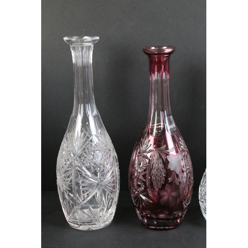 79 - Cranberry ruby etched glass wine decanter with grape and leaf design together with two cut glass dec... 