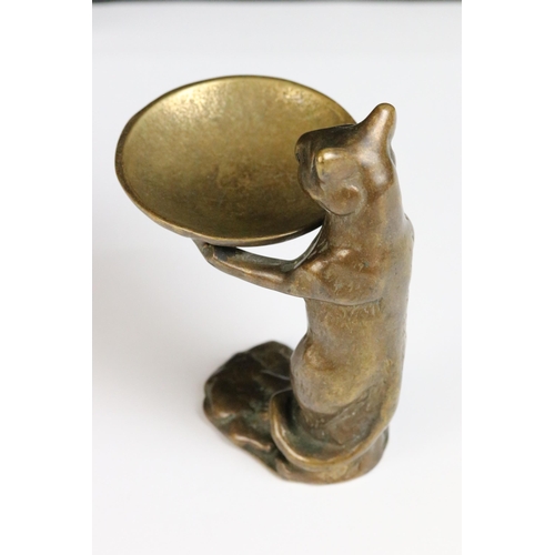 85 - A bronze figure of a standing cat holding a tray.