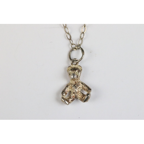 86 - Silver knot pendant set with an amethyst coloured stone on silver chain, silver gilt ‘ world ‘ penda... 