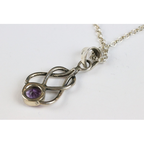 86 - Silver knot pendant set with an amethyst coloured stone on silver chain, silver gilt ‘ world ‘ penda... 