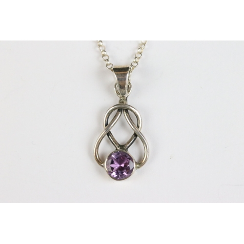 86 - Silver knot pendant set with an amethyst coloured stone on silver chain, silver gilt ‘ world ‘ penda... 