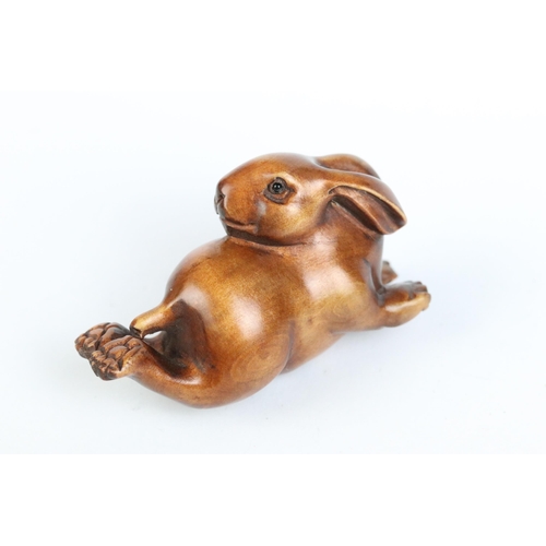 97 - A group of four fruit wood signed netsuke.