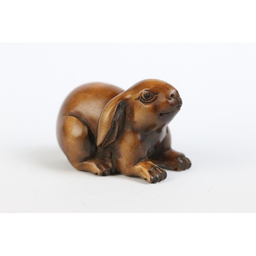 97 - A group of four fruit wood signed netsuke.