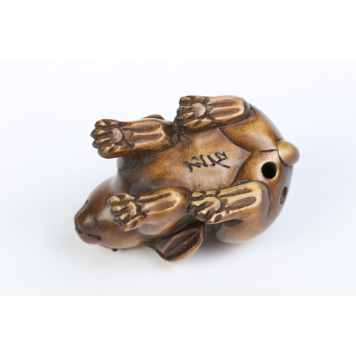 97 - A group of four fruit wood signed netsuke.