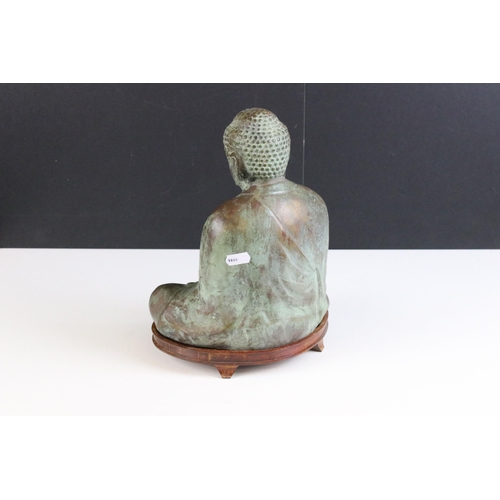 183 - Bronze Buddha sat on wooden base, measures approx. H 30cm